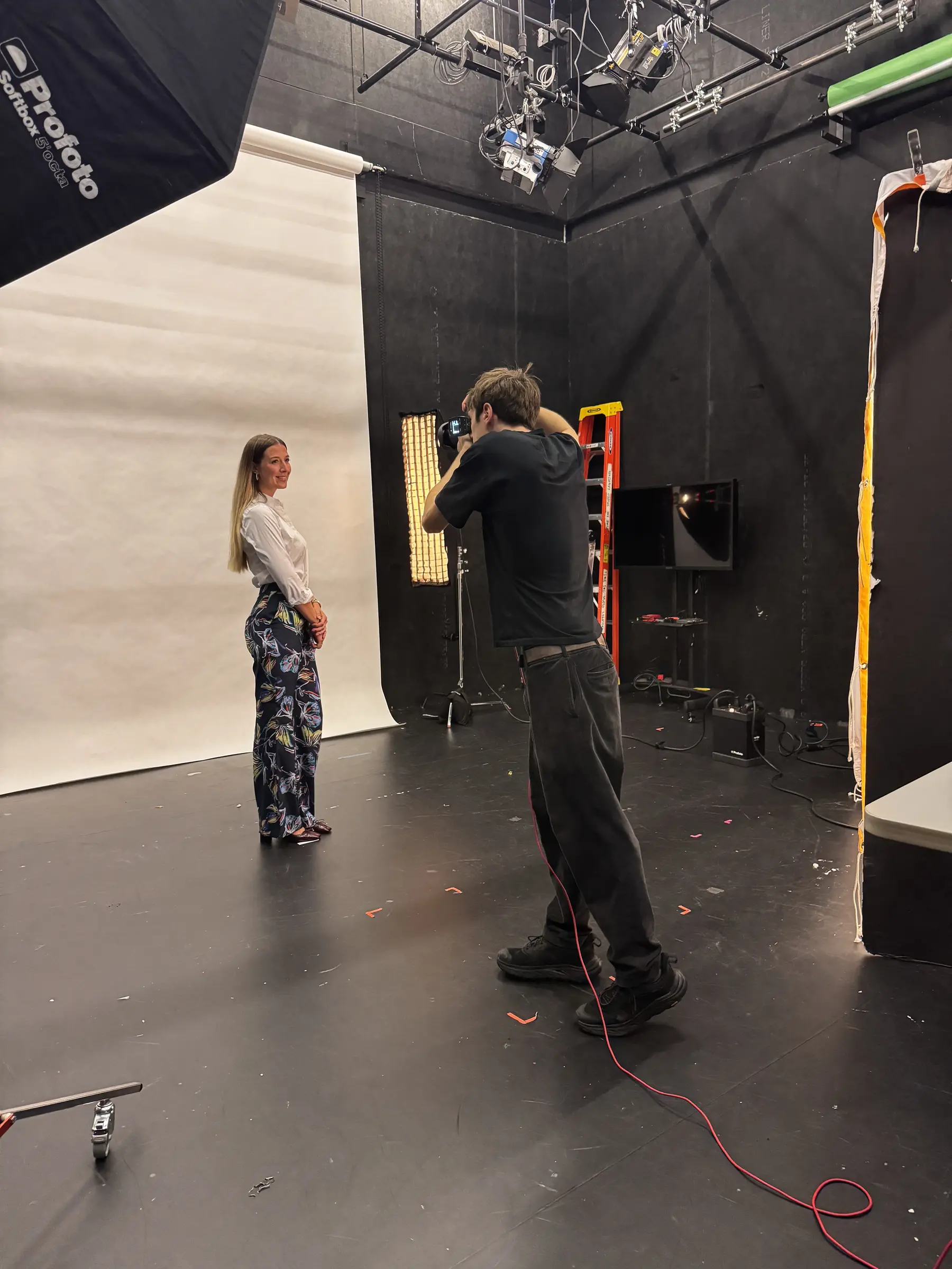 Nick Junk photographing a subject in a studio